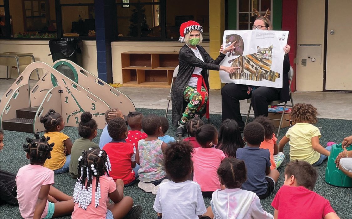 Lauri Kalanges, of Humana, reads to a preschool class at the PA Geraci Child Development Center in Fort Myers.